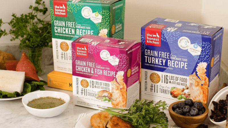 The Honest Kitchen Grain Free cat food recipes are displayed with fresh ingredients. Shop healthy, high quality, human grade dehydrated cat food from The Honest Kitchen.
