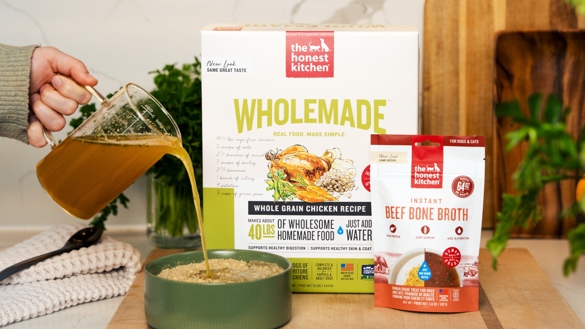 The Honest Kitchen Wholemade pet food packaging with a hand pouring broth into a bowl. Subscribe to The Honest Kitchen human grade pet food.