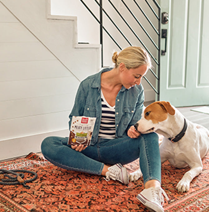 Woman giving dog treats