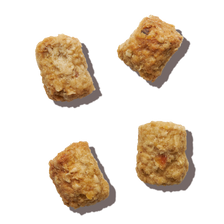 Four pieces of The Honest Kitchen's Whole Food Clusters dry cat food.
