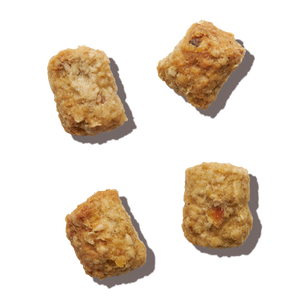 Four pieces of The Honest Kitchen's Whole Food Clusters dry cat food.