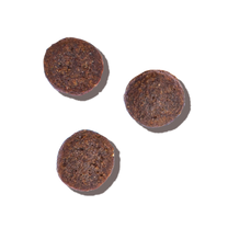 3 pieces of brown dry cat food. Whole Food Clusters dry cat food from The Honest Kitchen.