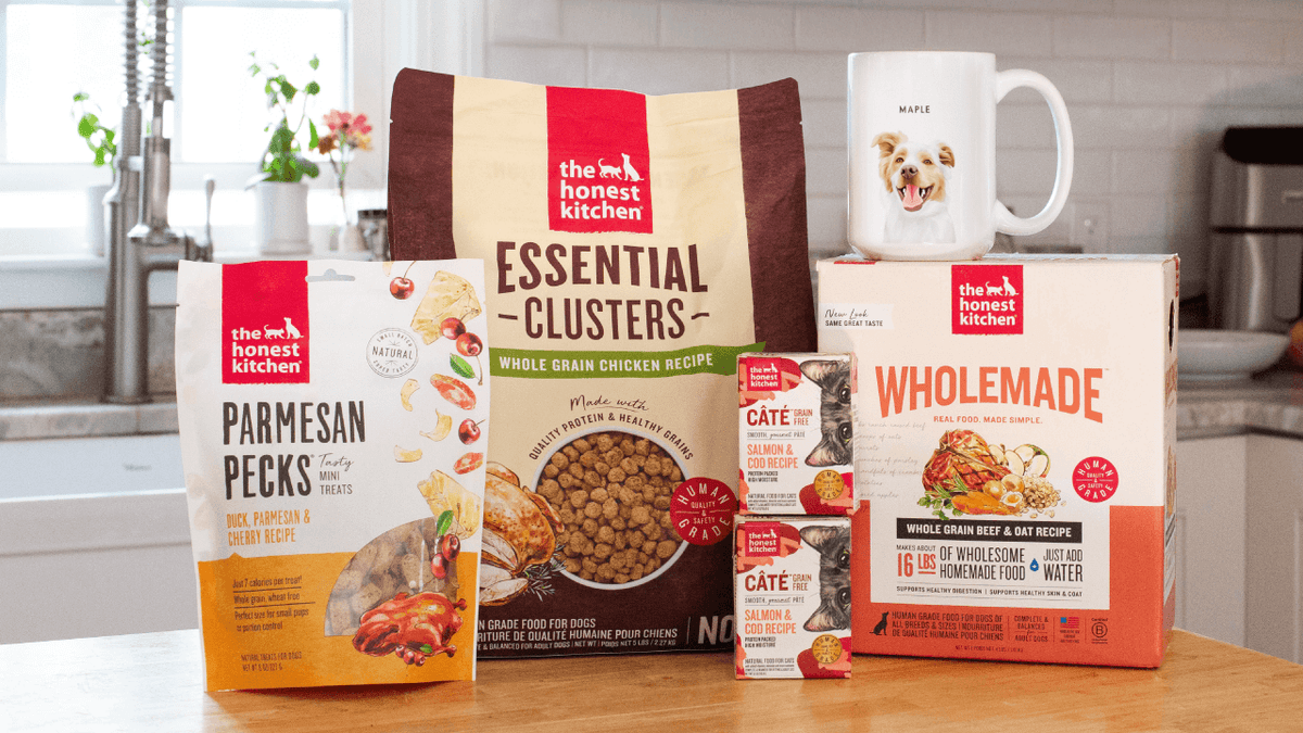Picture of The Honest Kitchen dog food, treats, cat food, and mug with dog face.  Healthy, high quality, human grade food for dogs and cats.